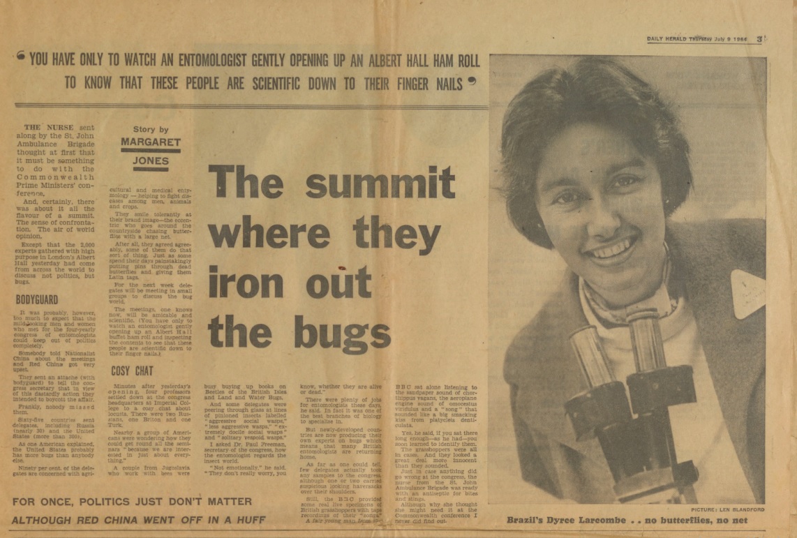 Imagem de uma matéria jornalística sobre evento de entomologia traz foto de uma mulher sorrindo com um microscópio. Ela é Dyrce Lacombe